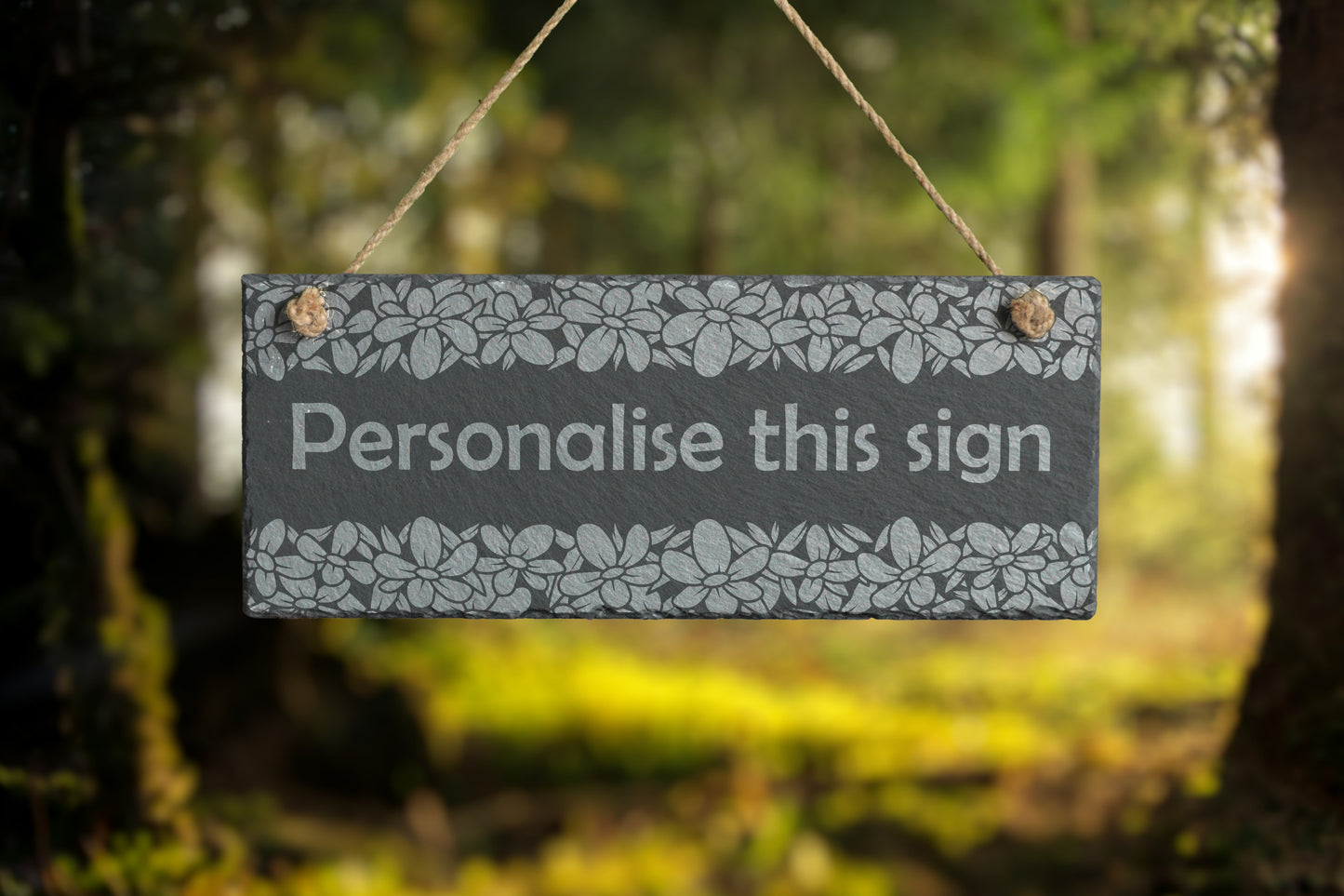 Decorative slate sign with 'Personalise this sign' text in a forest setting