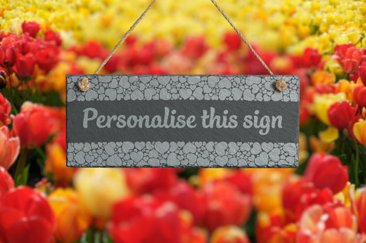Decorative slate sign with 'Personalise this sign' text in front of colourful tulips