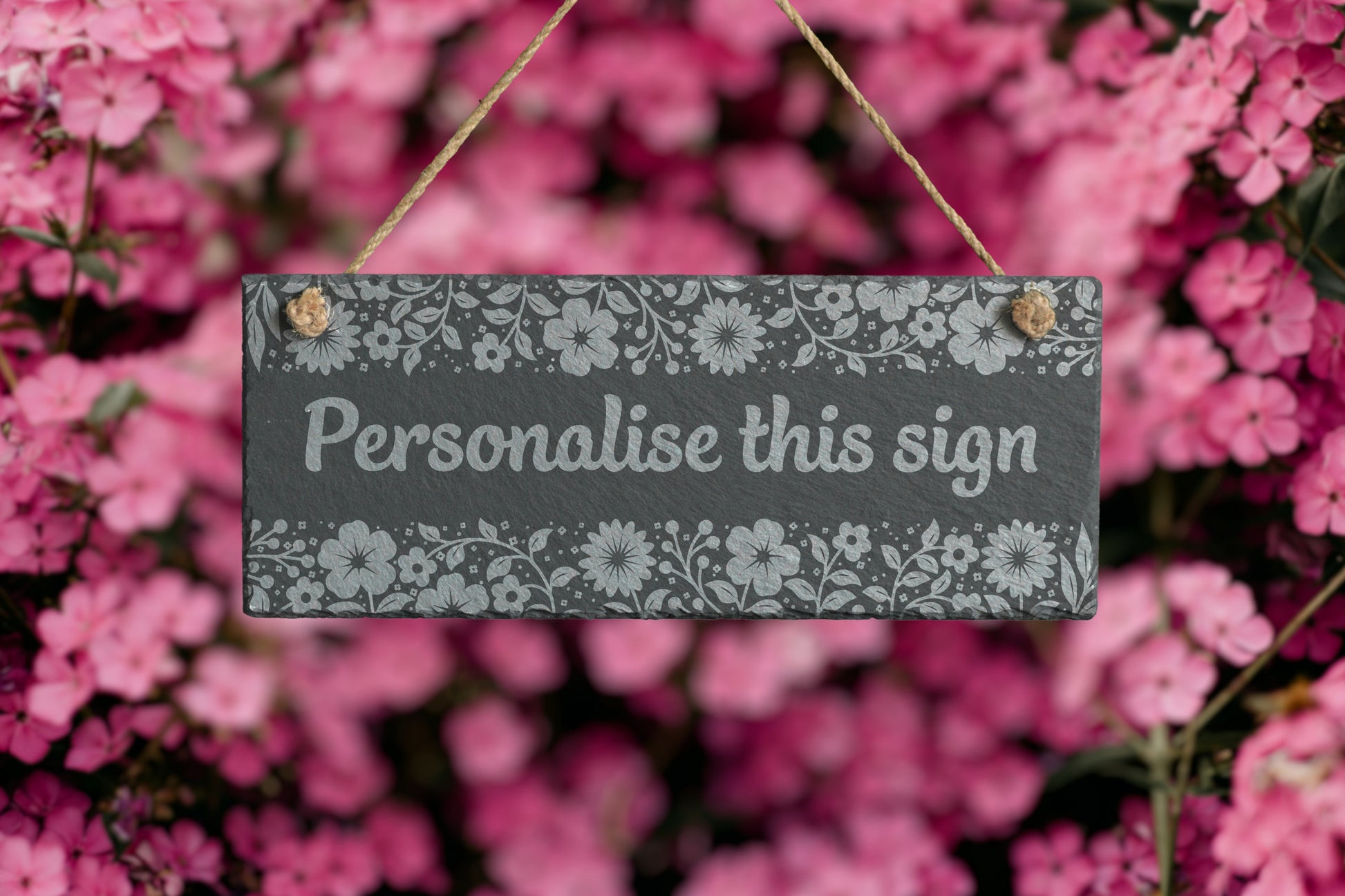 Decorative sign with floral pattern and text 'Personalise this sign' against a pink floral background